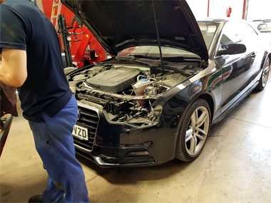 Audi A5 with headlight taken out for realignment Audi A5 in workshop